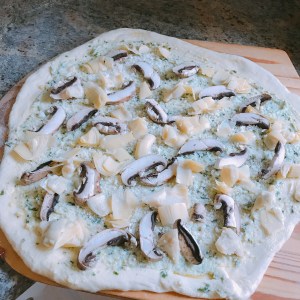 artichoke mushroom pizza ready for oven