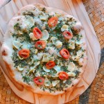 pizza w pesto, artichokes, spinach and tomato